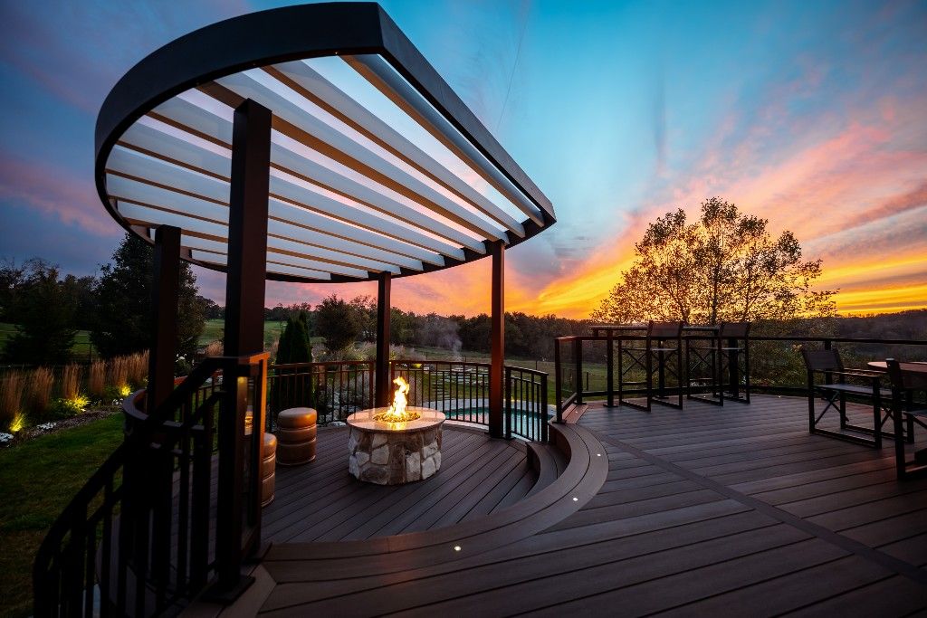 Modern deck with curved pergola and fire pit