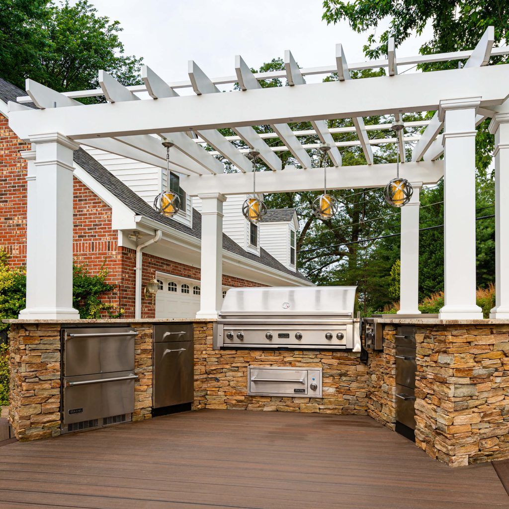 Outdoor Kitchen with Pergola by SCPC Construction